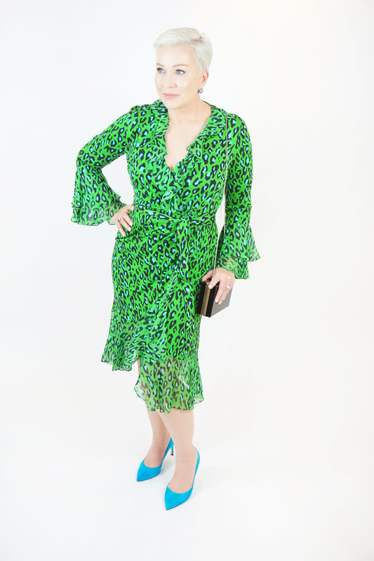 Mrs. Stafford poses in a lime green & blue leopard print wrap dress with blue high heels