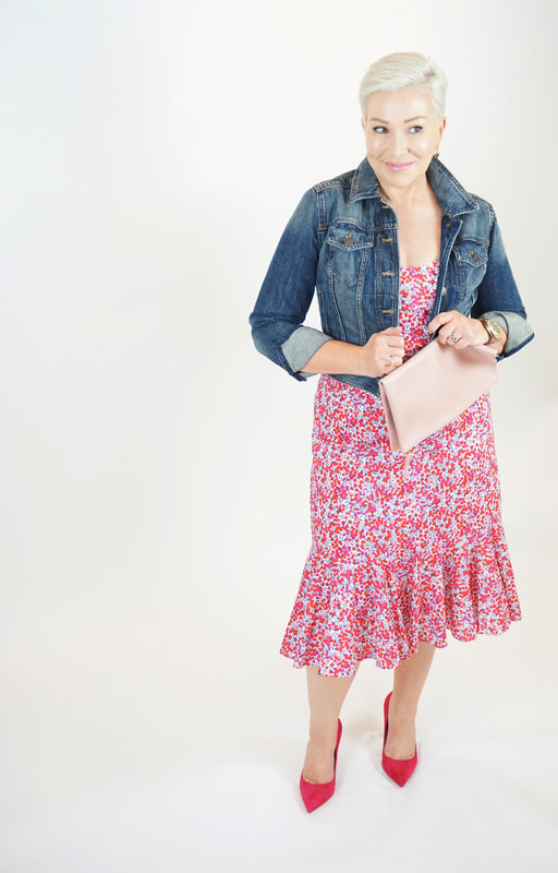 Mrs. Stafford in a flirty, floral dress, jean jacket, pink heels & clutch