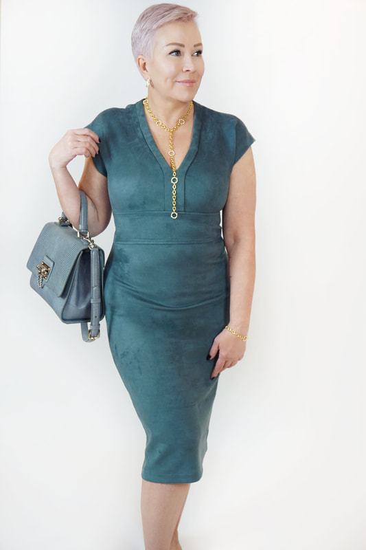 Mrs. Stafford wearing a green, suede midi dress​ and a matching purse