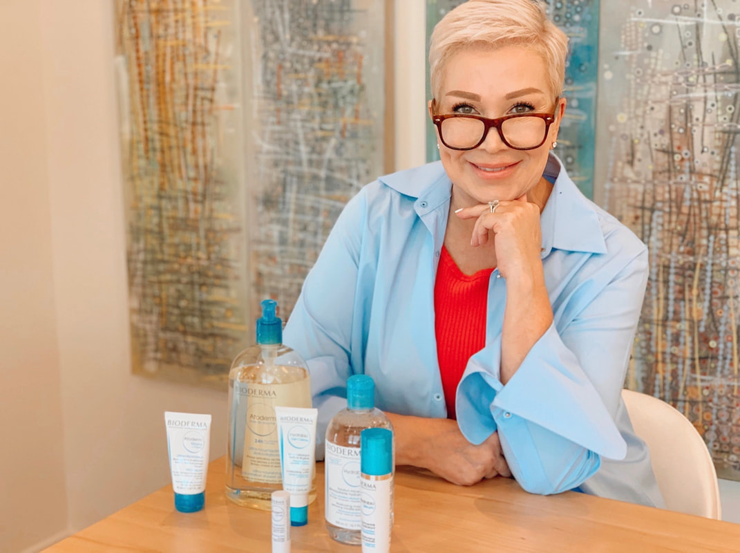 Mrs. Stafford sitting at a table with Bioderma products laid out