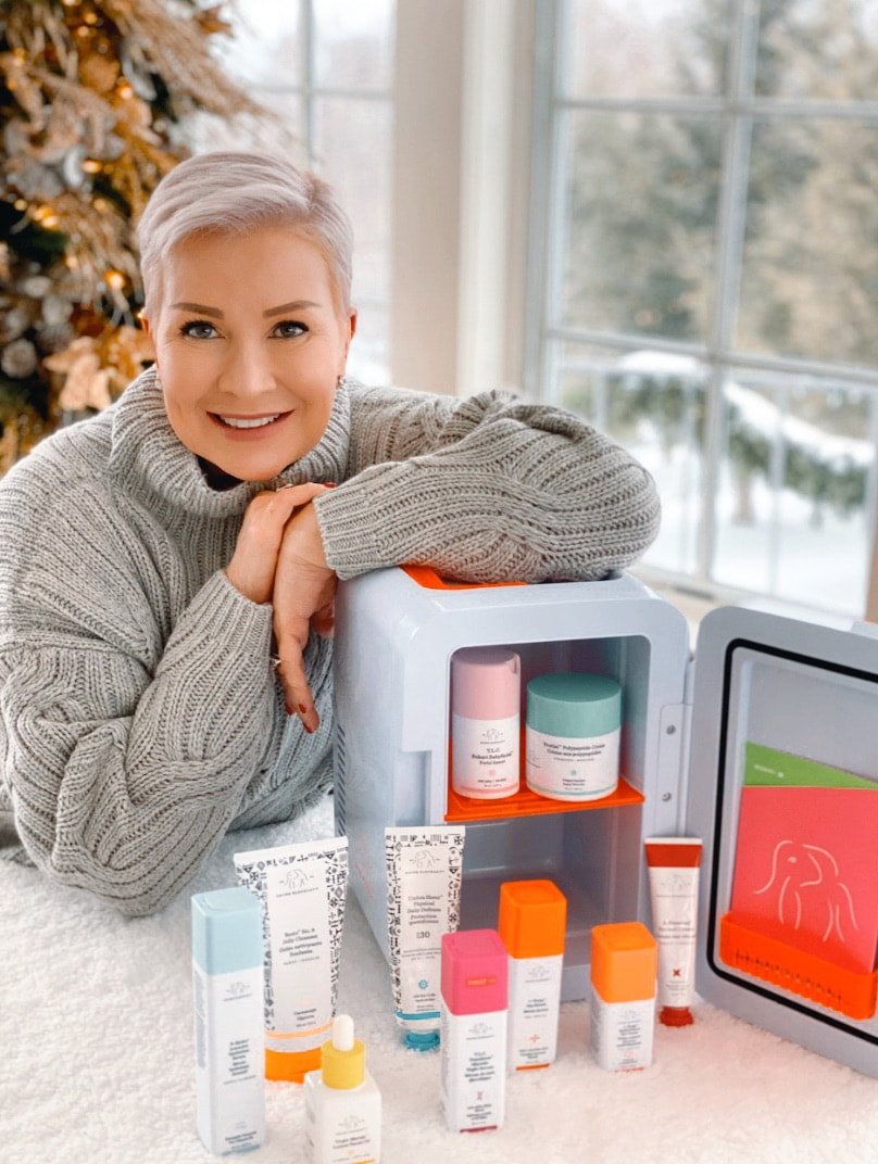 Mrs. Stafford leans on the Drunk Elephant 3.0 Trunk filled with skincare products