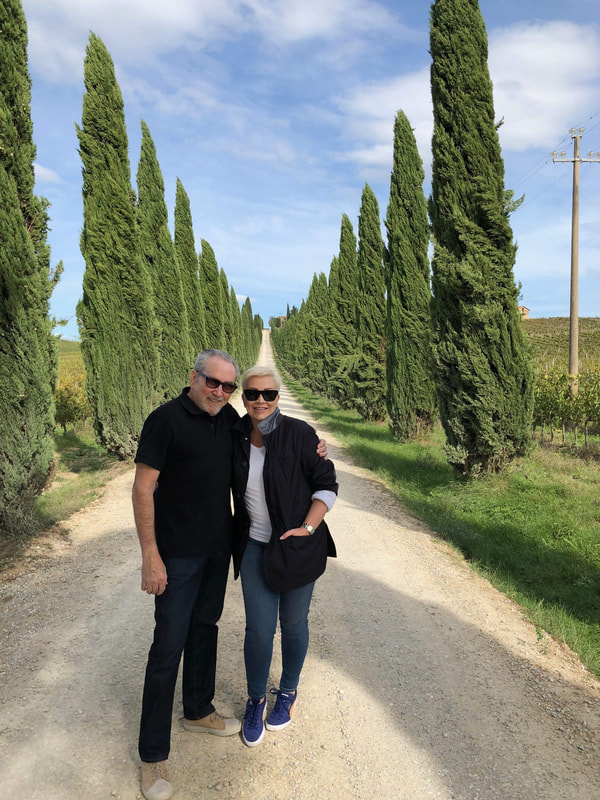 Mr. & Mrs. Stafford smiling in a Vineyard in Tuscany